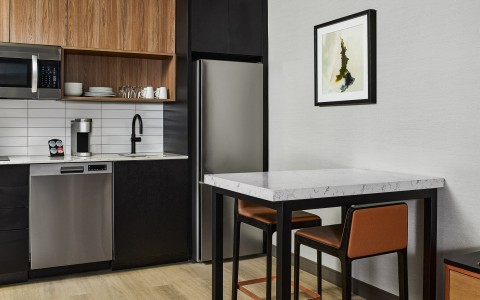 a kitchen with a table and chairs