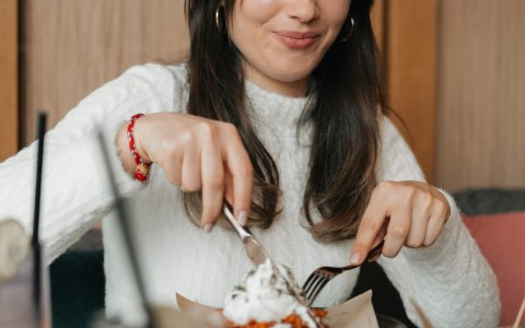 a woman eating a dessert