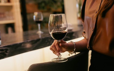 a person holding a glass of wine