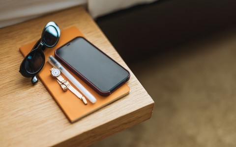 a phone and sunglasses on a table