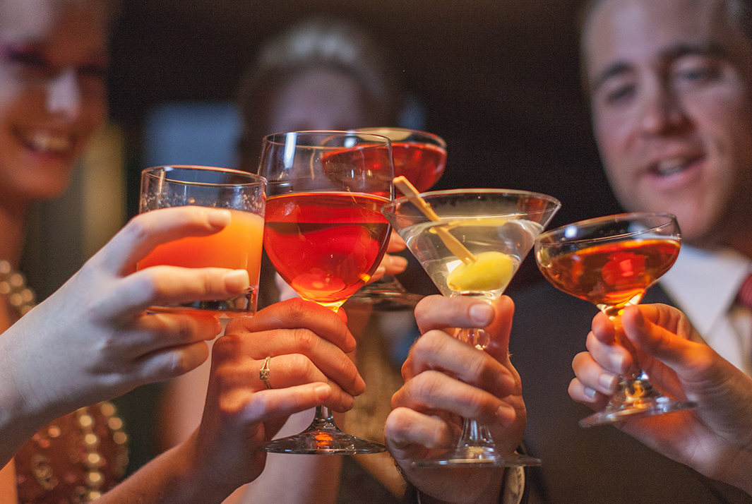 a group of people holding up glasses