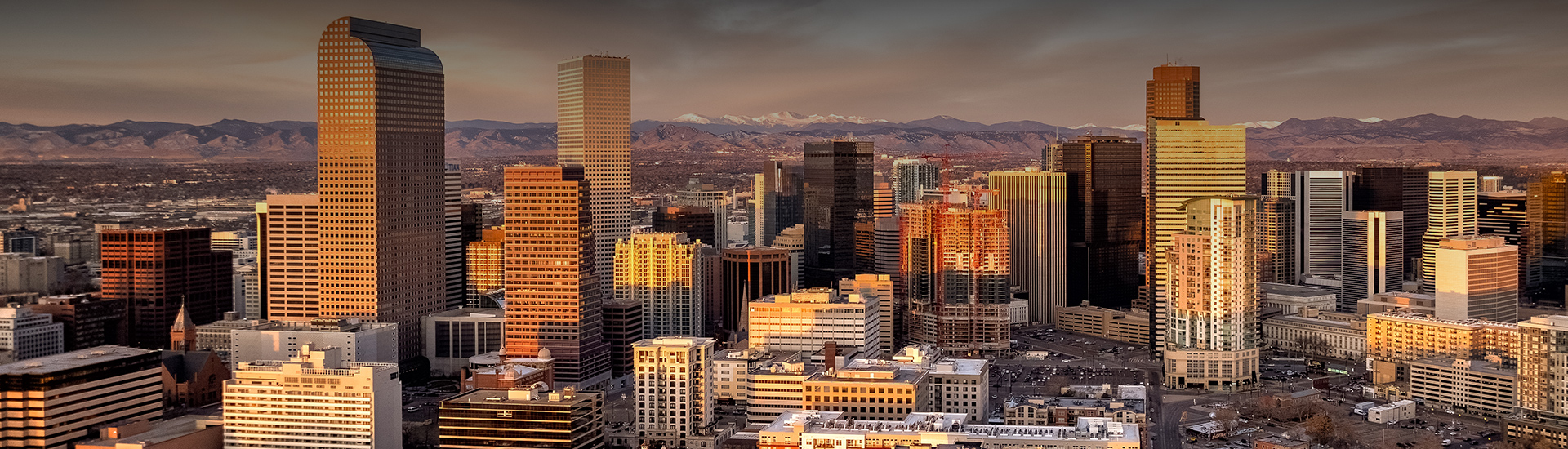 a city with tall buildings and mountains in the background