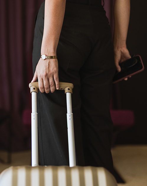 a person holding a luggage handle