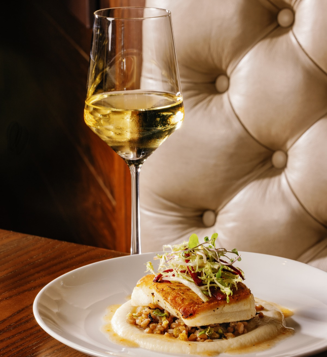 a plate of food and a glass of wine