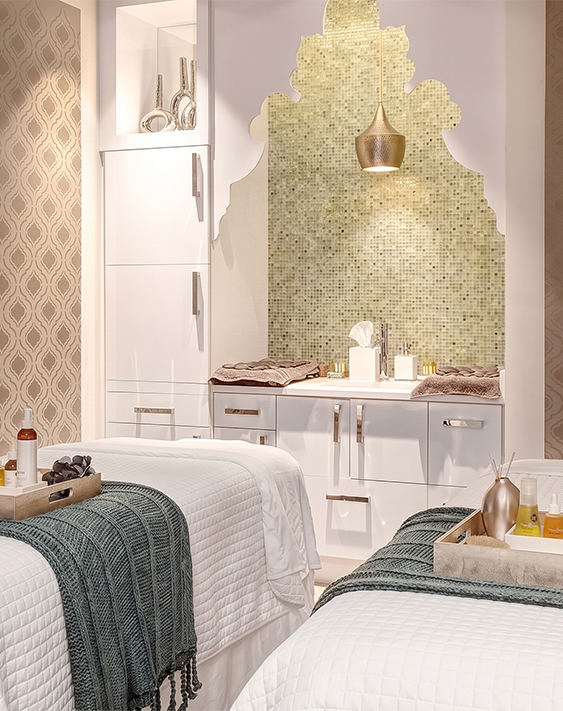 a room with two beds and a mirror