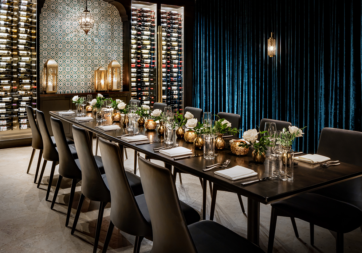 a long table with white flowers and candles on it