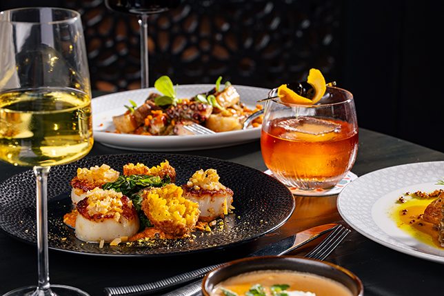 a table with plates of food and drinks