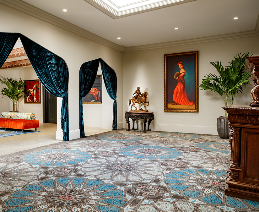 a room with a blue and white patterned floor and a blue curtain