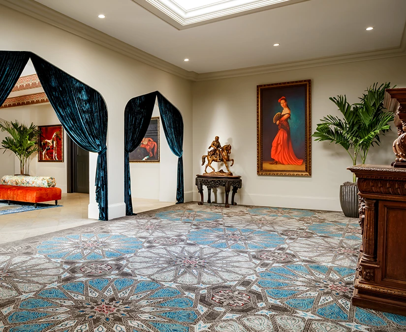 a room with a blue and white patterned floor and a blue curtain