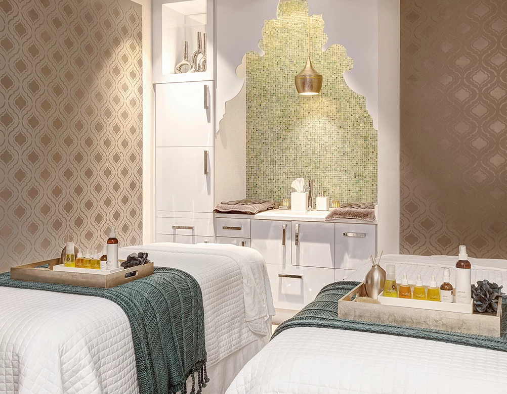 a room with two beds and a tray of food
