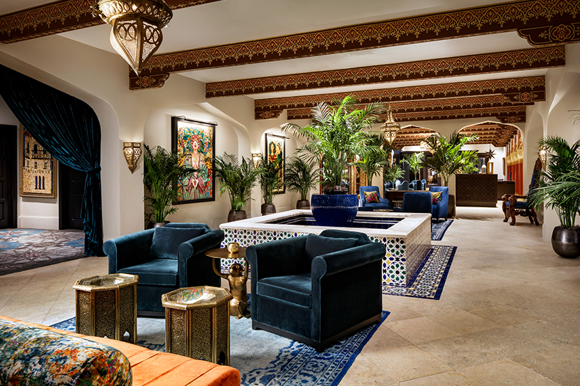 a room with blue chairs and a pool
