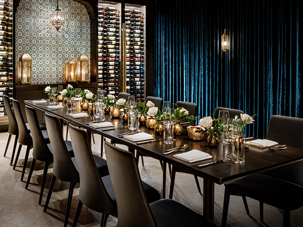 a long table with chairs and flowers