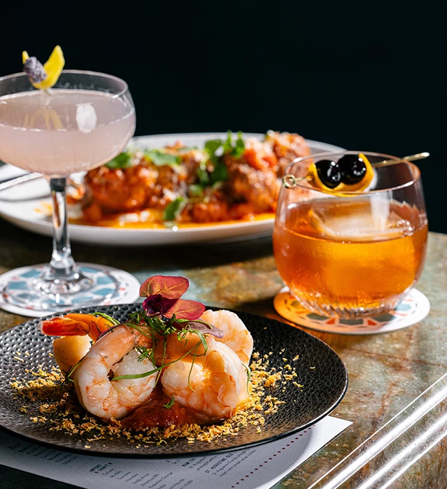 a plate of food and a drink on a table