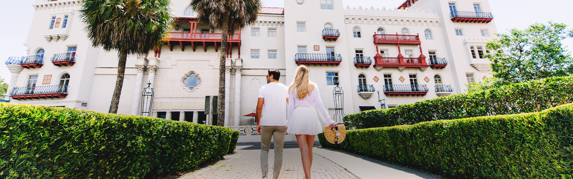 a man and woman walking down a sidewalk
