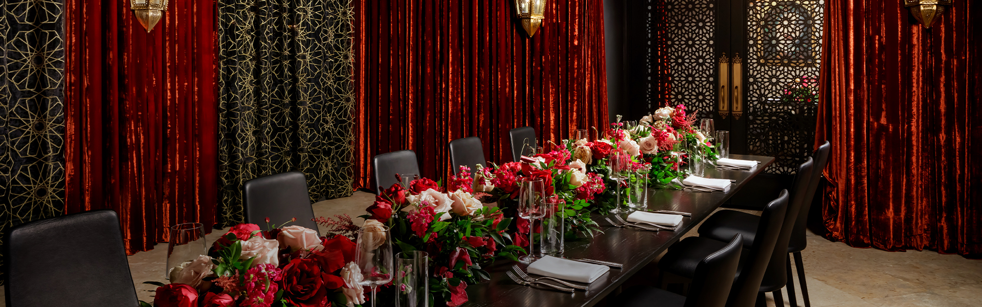 a table with flowers and glasses on it