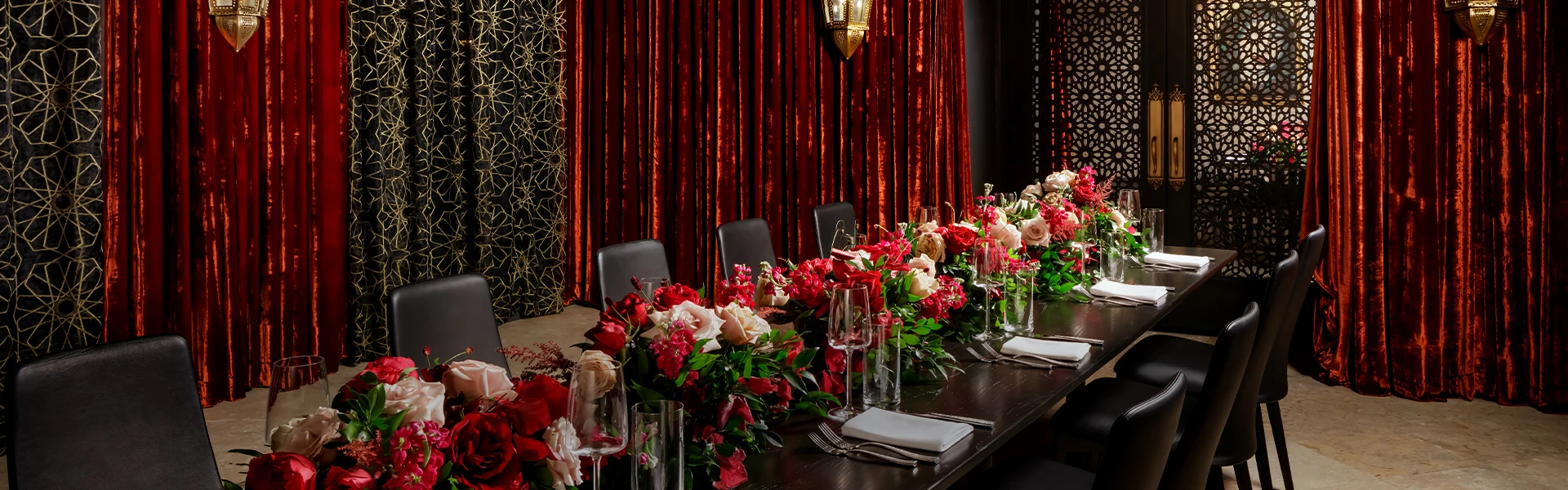 a table with flowers and glasses on it