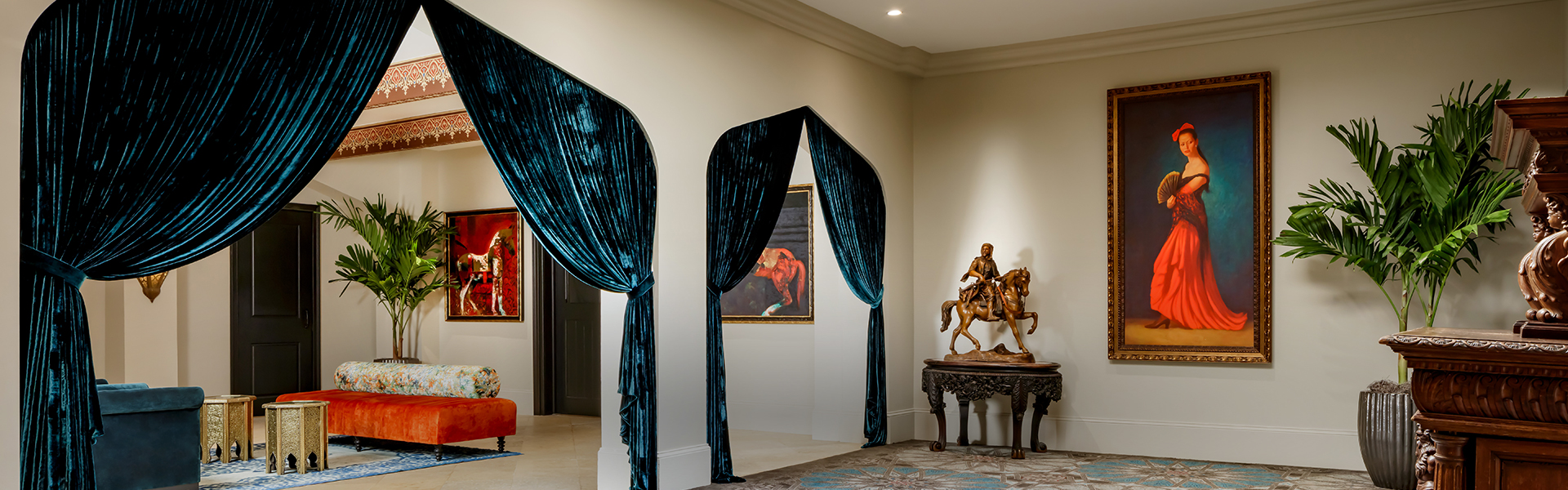 a room with blue curtains and a statue