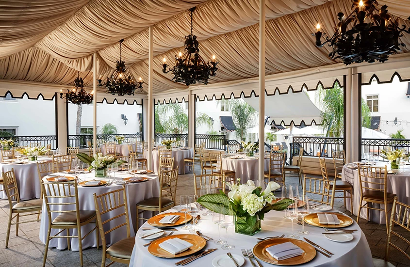 a set tables with gold plates and silverware