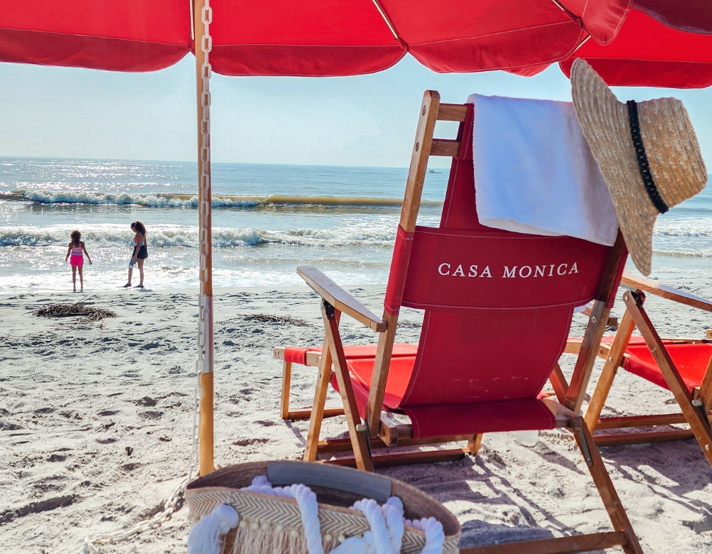 a beach chair and umbrella on a beach