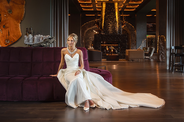 a woman in a white dress sitting on a purple couch