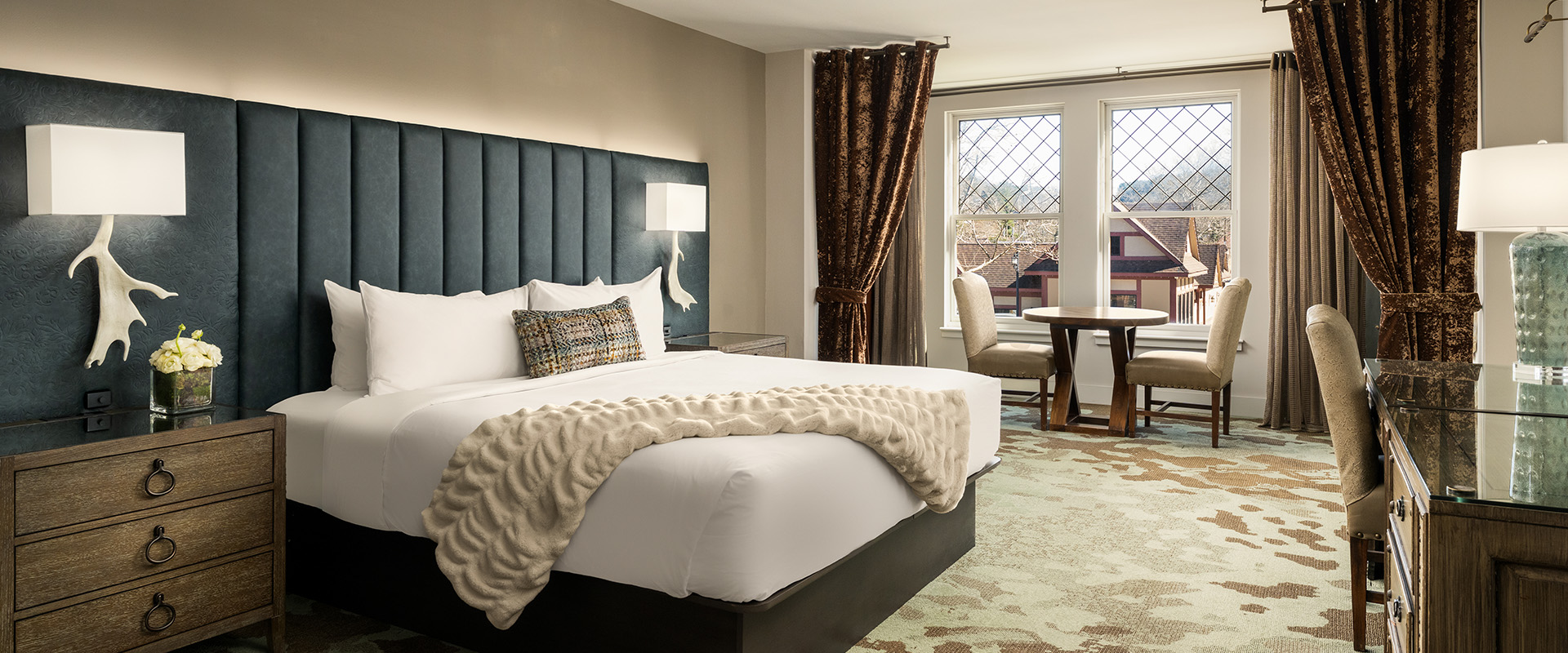 a hotel room with a bed and a table
