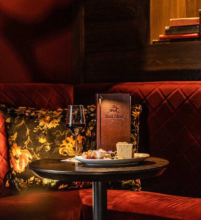 a table with food and a glass of wine on it