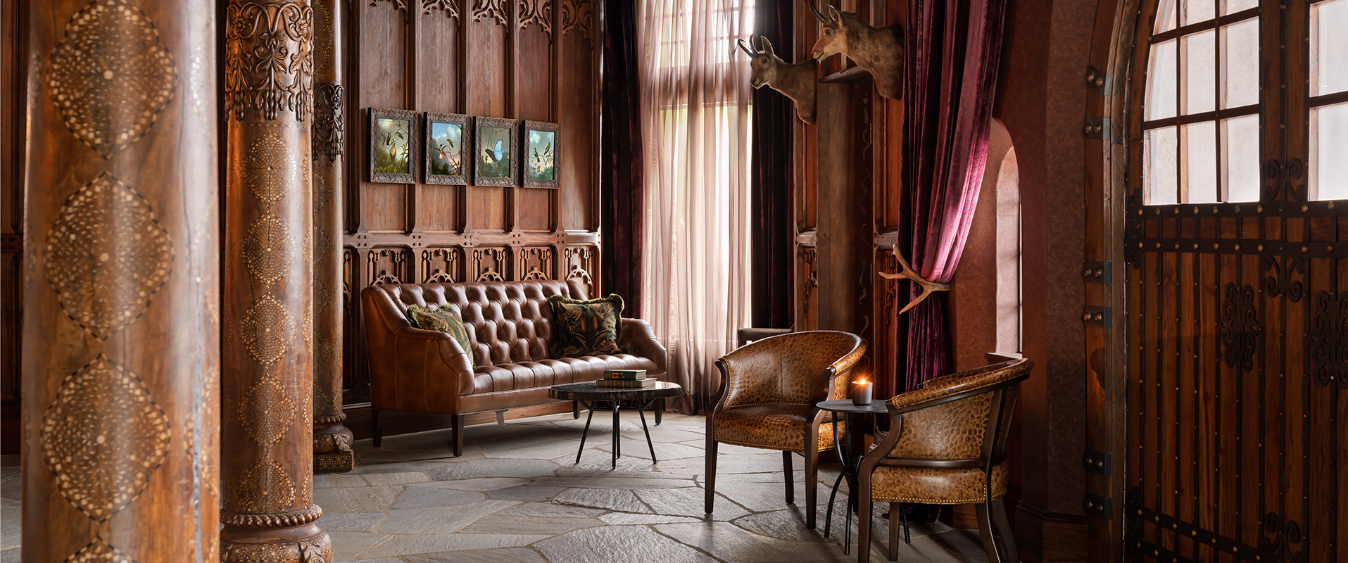 a room with a couch and chairs