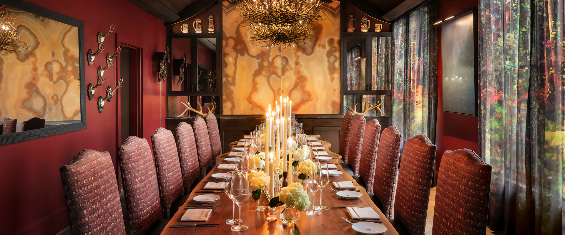 a long table with candles and wine glasses