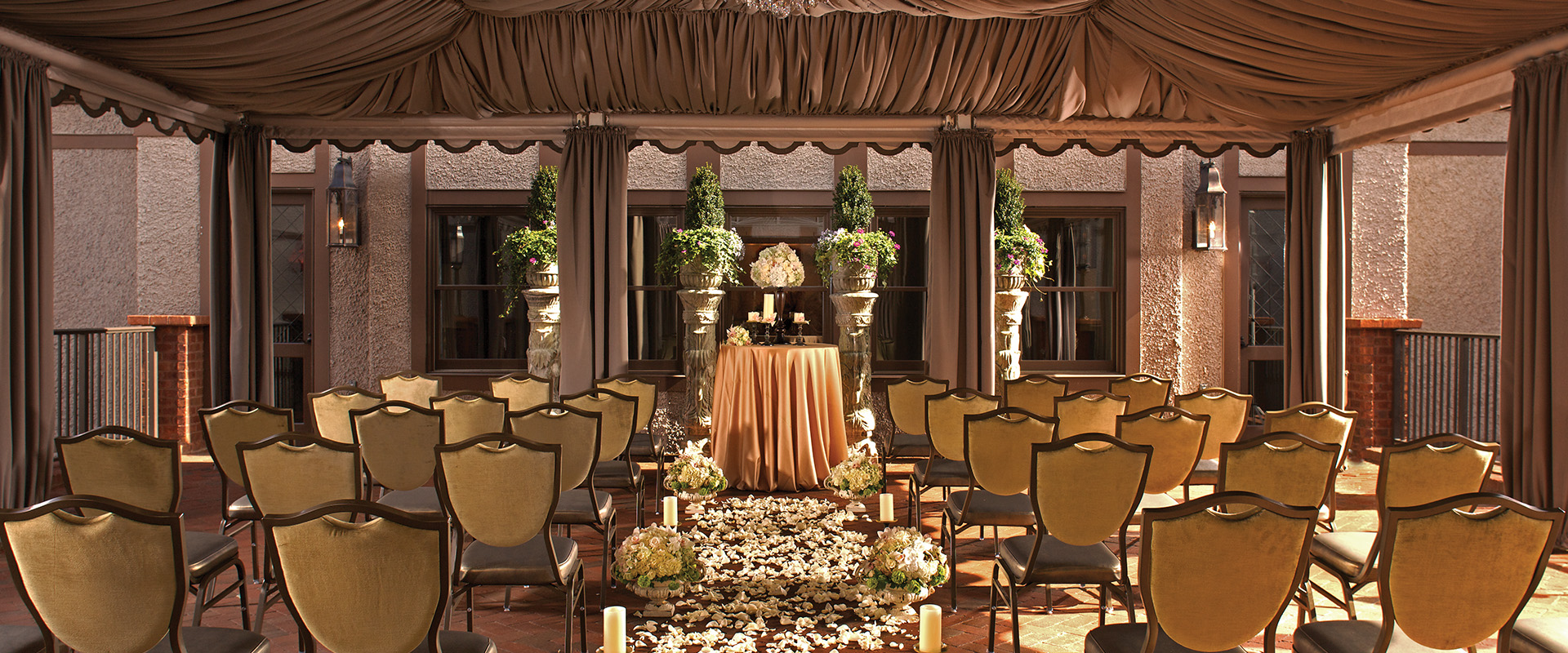 a wedding ceremony with chairs and flowers