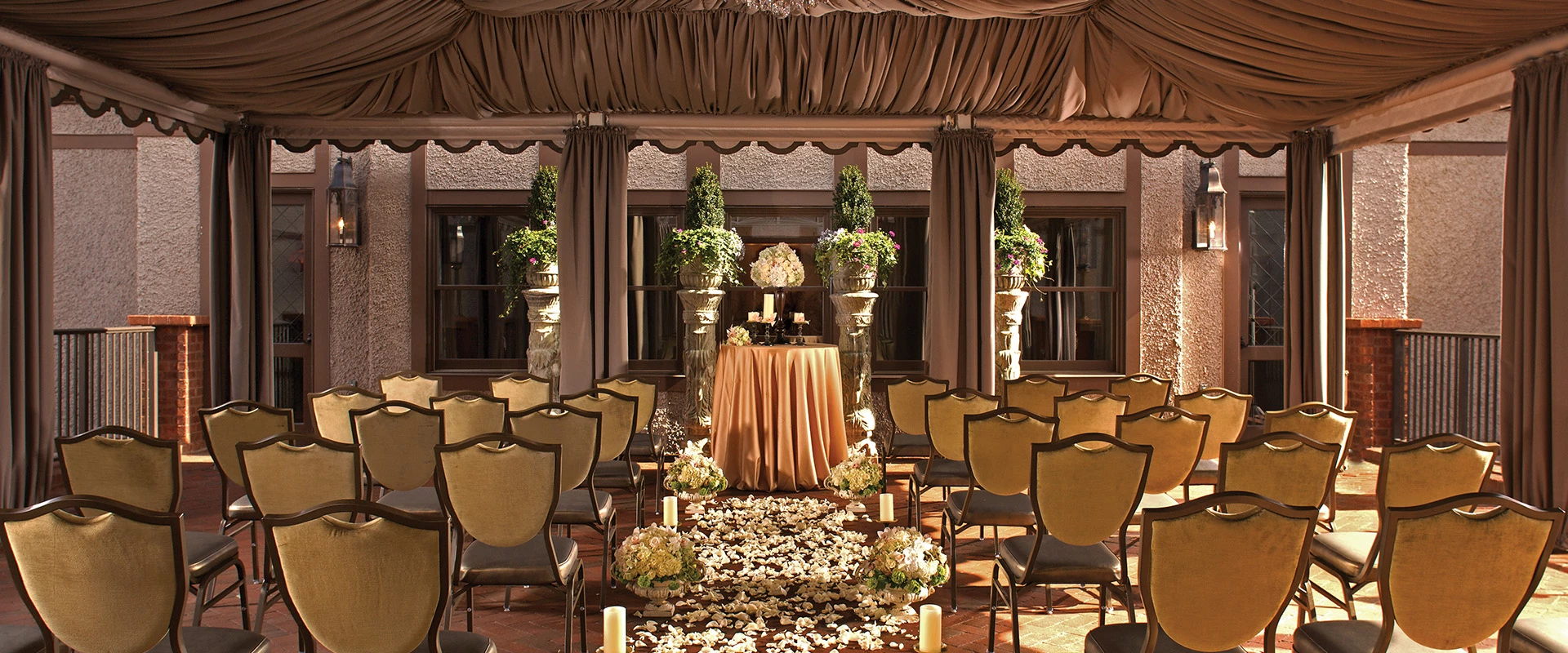 a wedding ceremony with chairs and flowers