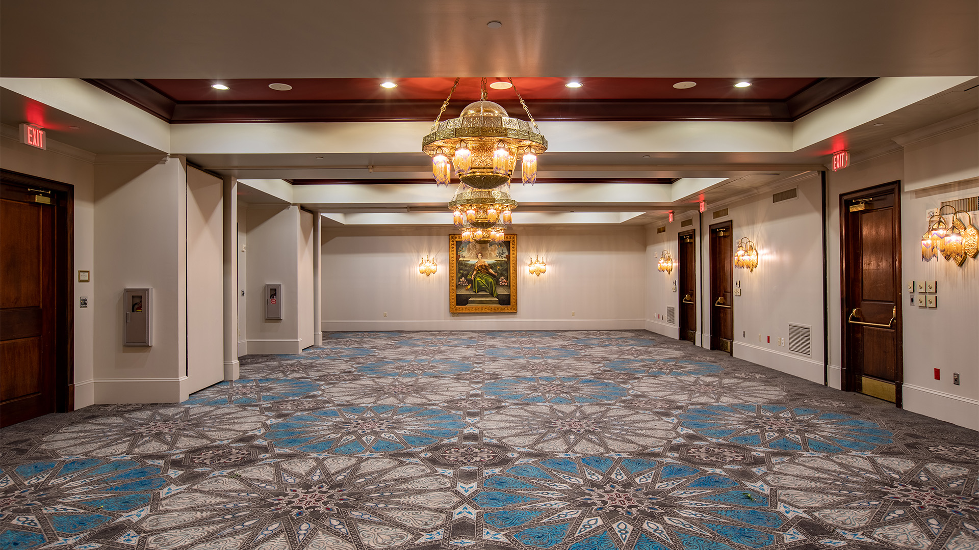 a large room with a chandelier and a patterned carpet
