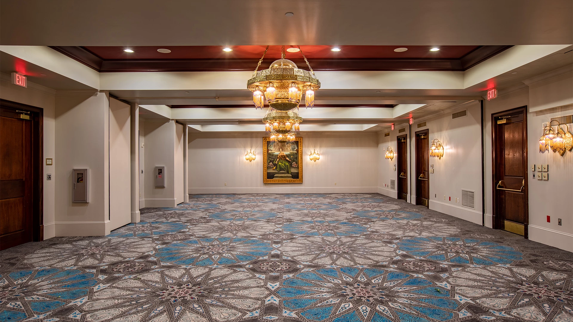 a large room with a chandelier and a patterned carpet