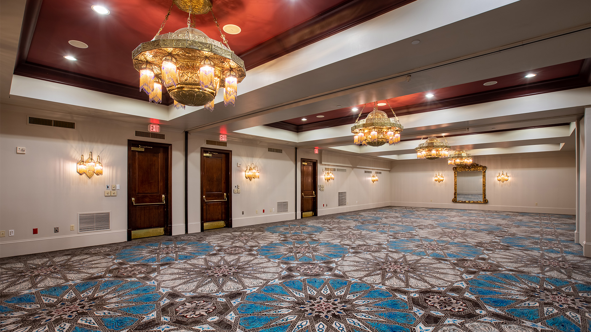 a room with chandeliers and doors