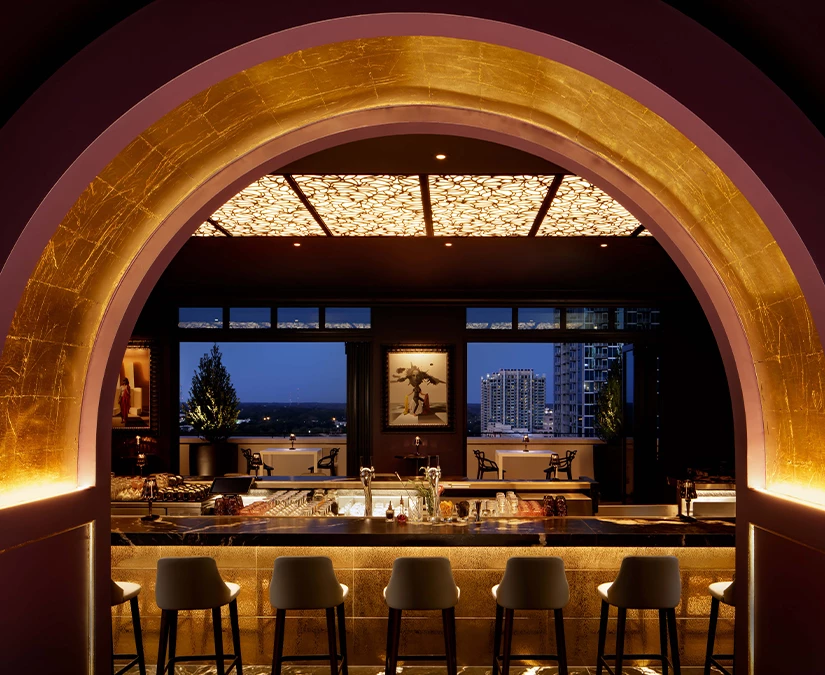 a bar with chairs and a bar in a restaurant