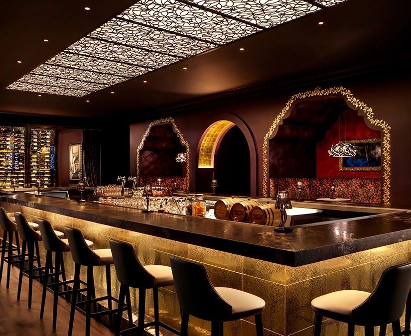 a bar with wine glasses and wine barrels