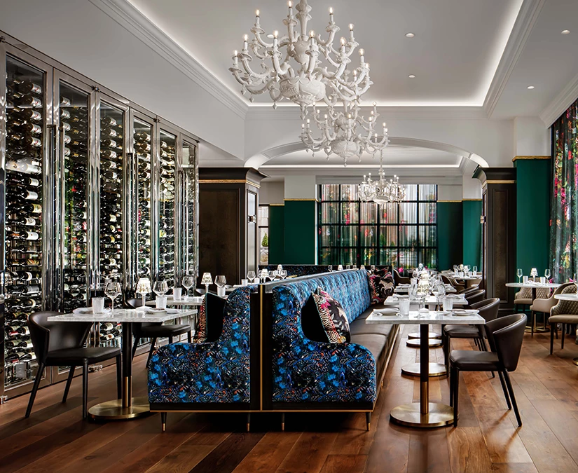 a restaurant with a chandelier and tables