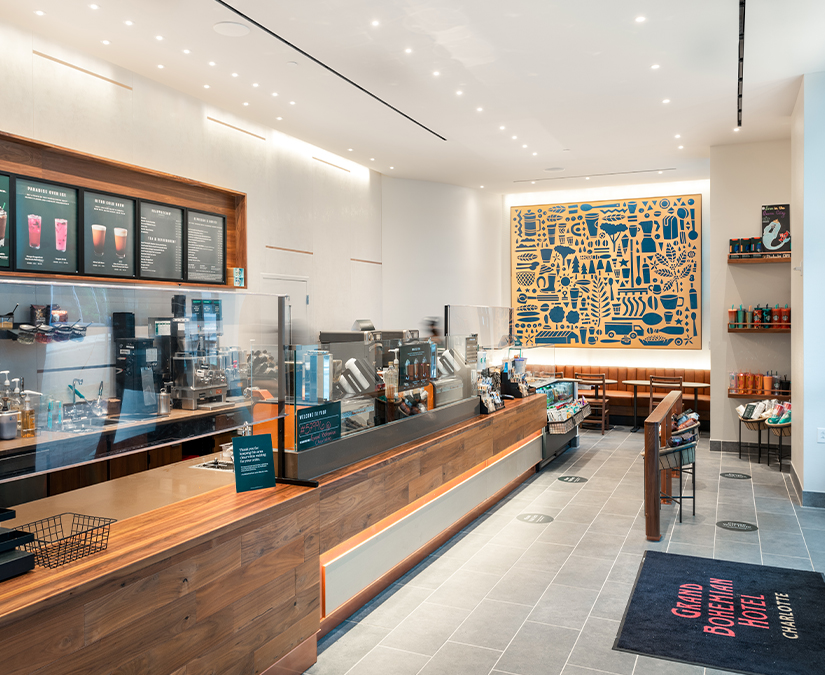 a coffee shop with a counter and a sign