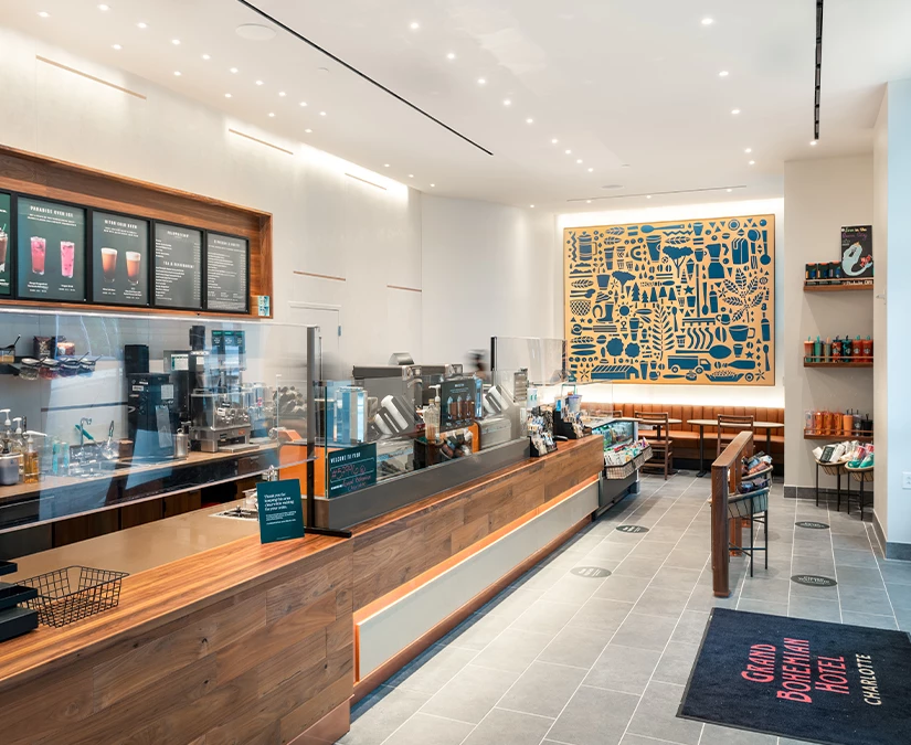 a coffee shop with a counter and a sign