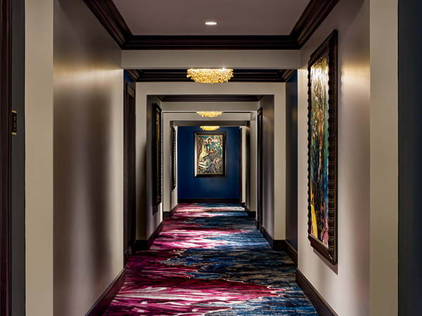 a hallway with artwork from the ceiling