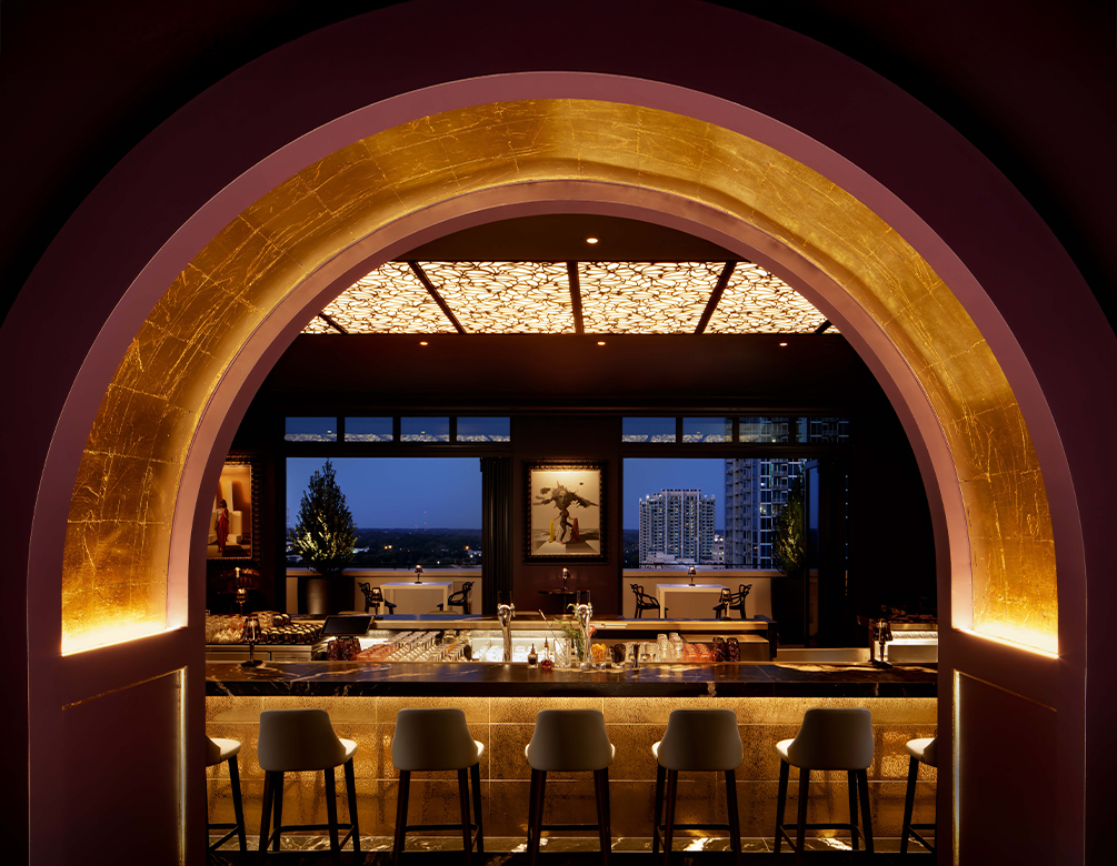a bar with stools and a bar counter