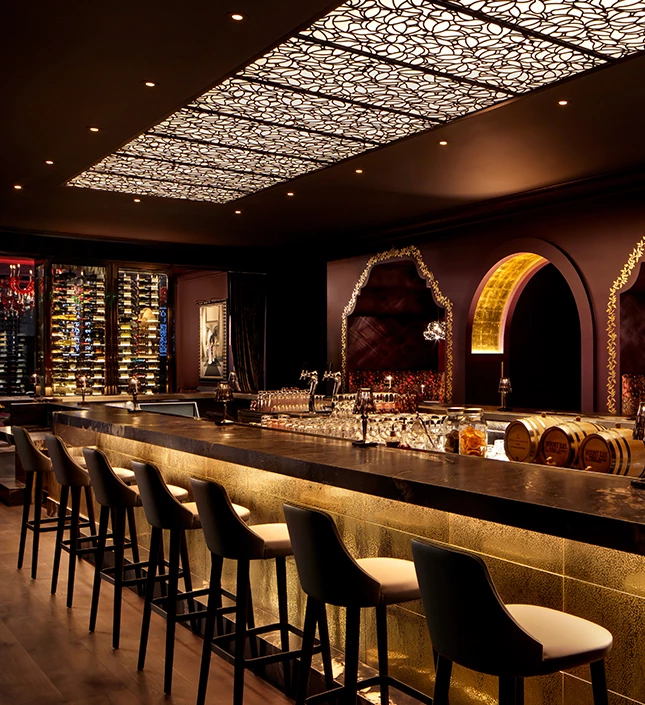 a bar with wine barrels and wine glasses