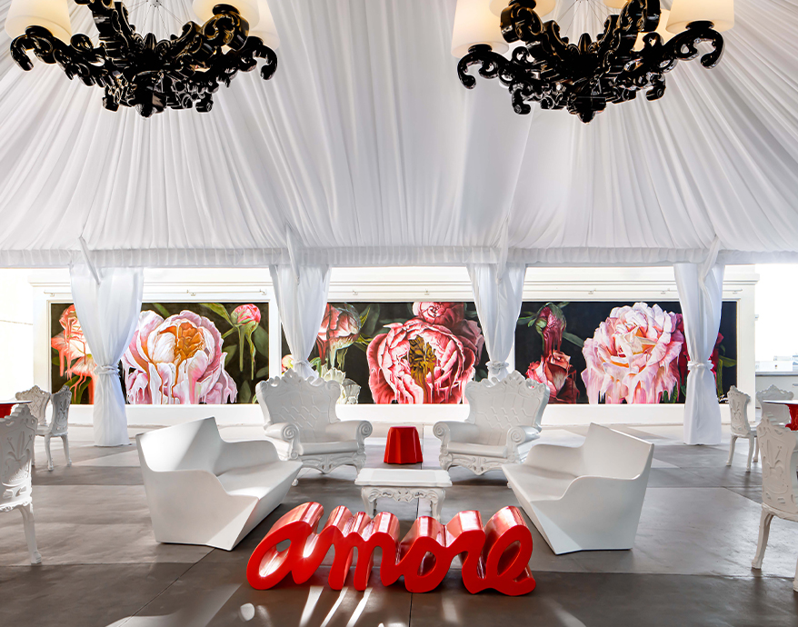 a white room with white chairs and a red table