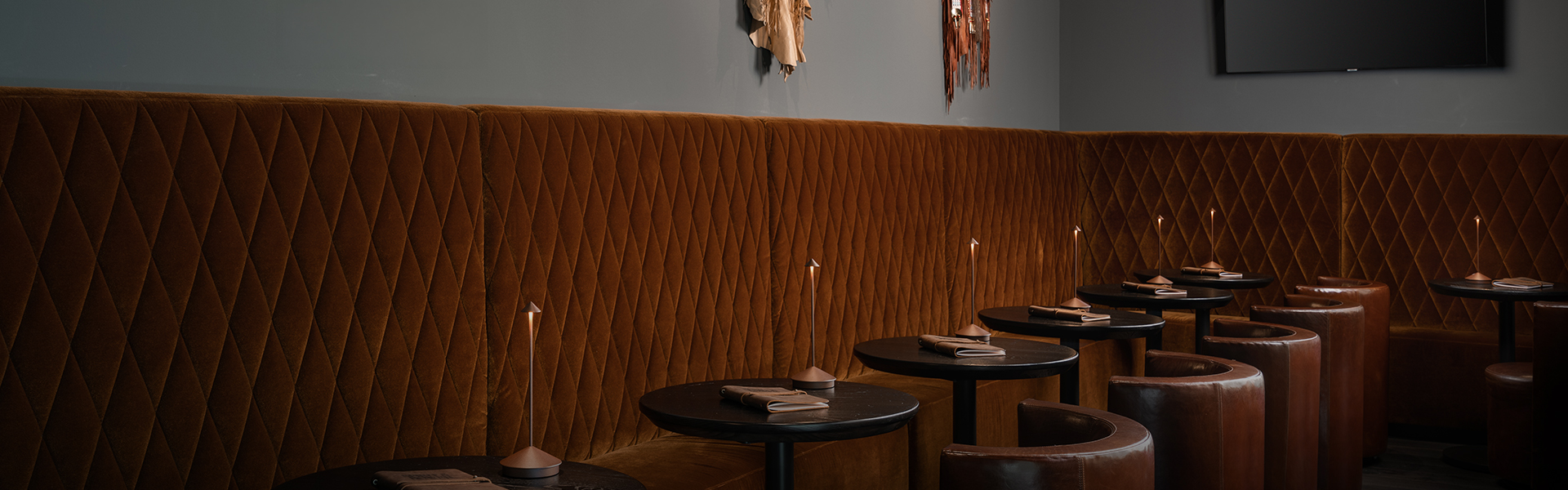 a table with napkins and candles in a booth