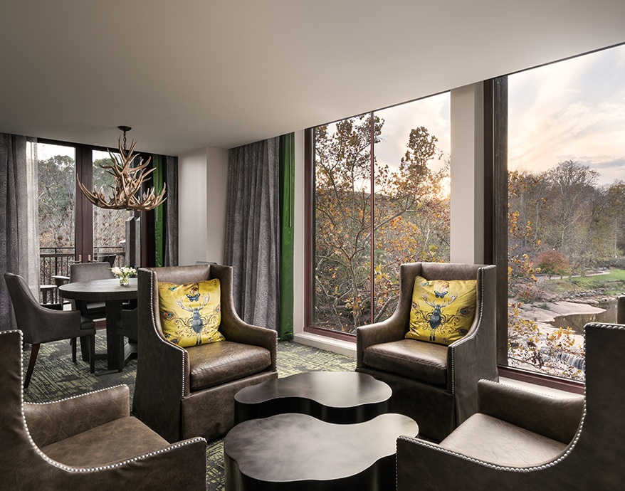 a room with chairs and tables and a large window