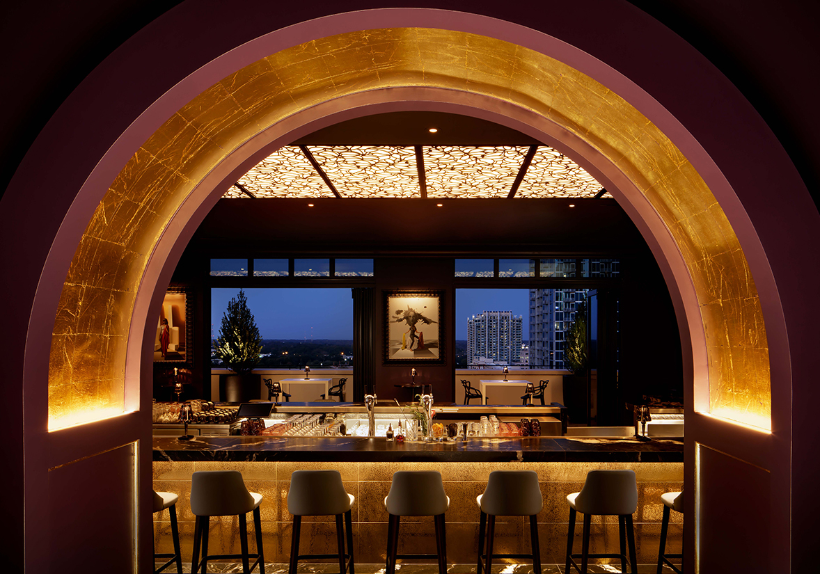 a bar with stools and a bar counter