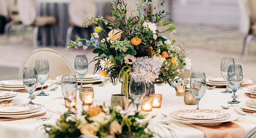 a table set with flowers and candles