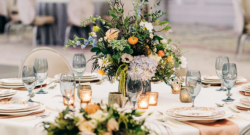 a table set with flowers and candles