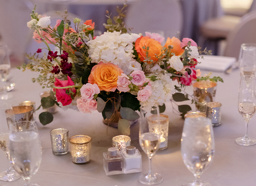a table with flowers and candles