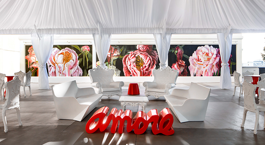 a room with white chairs and a red table