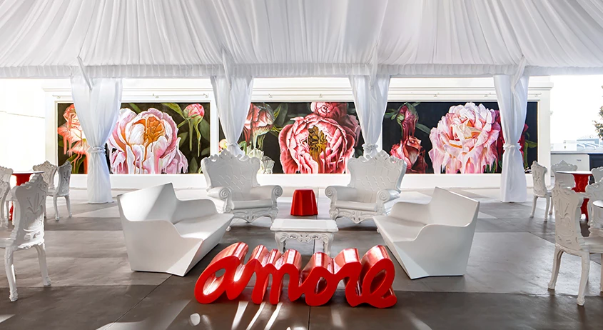 a room with white chairs and a red table